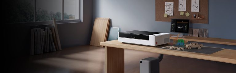 Bambu Lab R1 on a desk in a home workshop